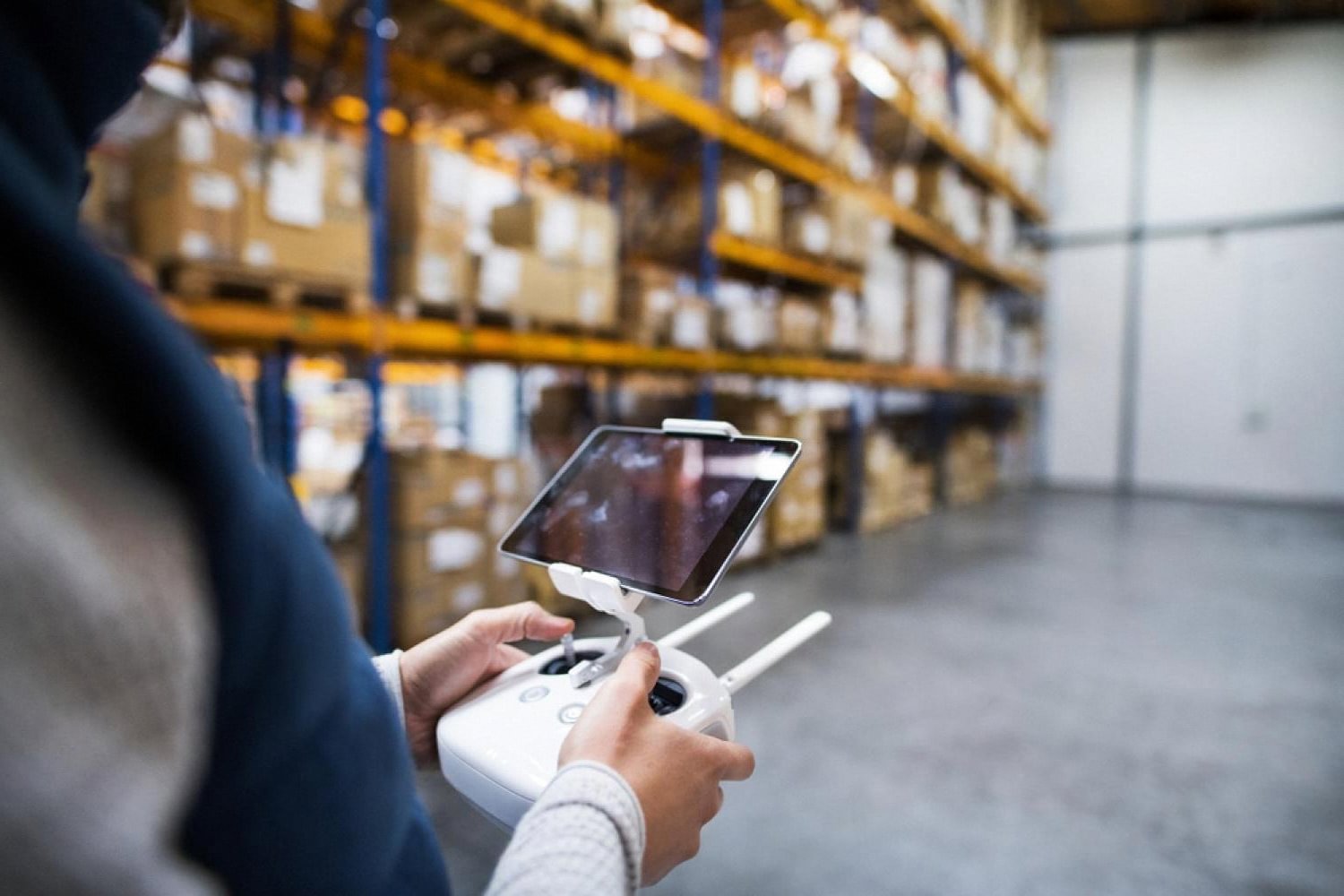 Warehouse worker checking inventory on a tablet inside a toy distribution centre