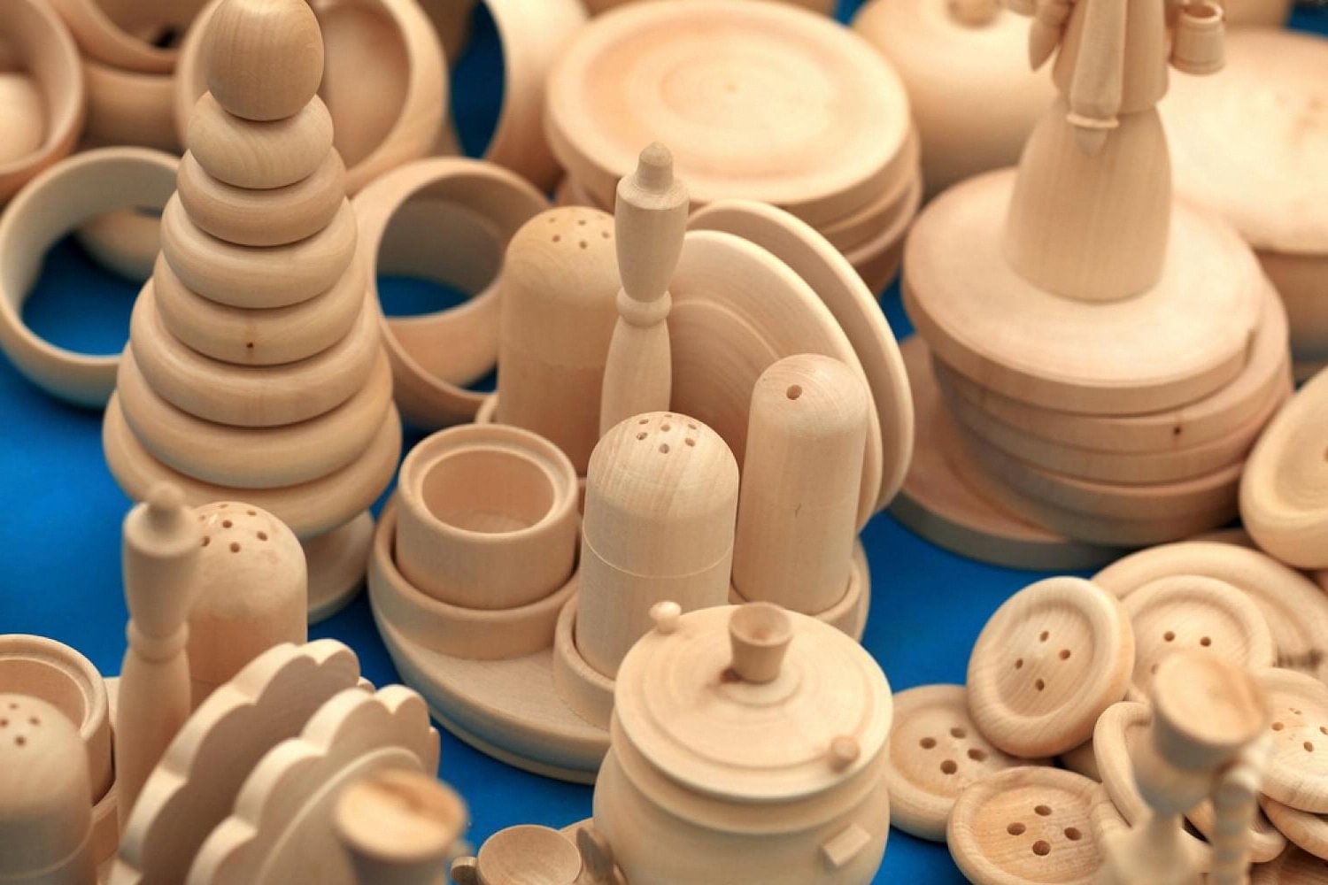 Wooden Montessori style educational toys arranged on a blue surface, popular with UAE resellers